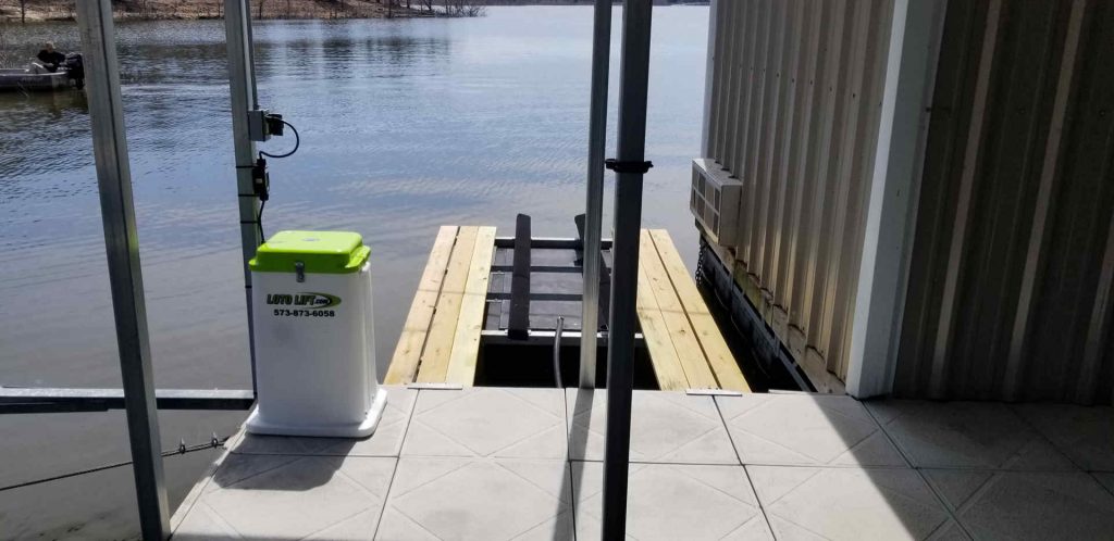Single jet ski lift with a control box on the dock.