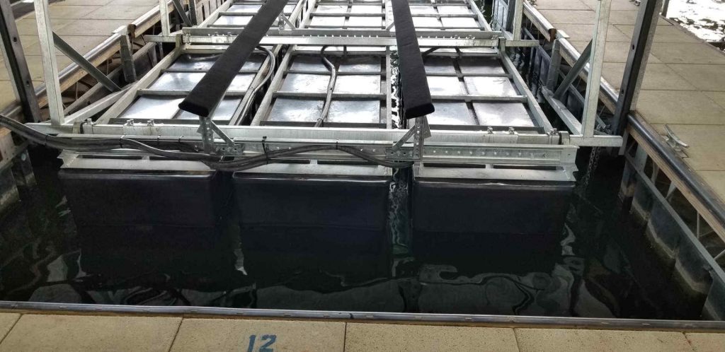 LOTO Lift LT Model parallel poly tanks in the slip with the galvanized steel frame kept above the waterline.
