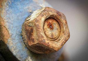 A heavily rusted bolt and nut.