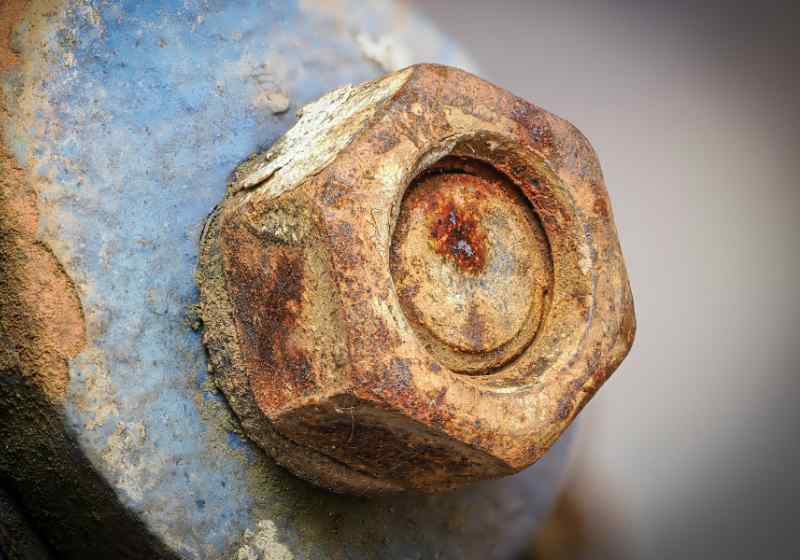 A heavily rusted bolt and nut.