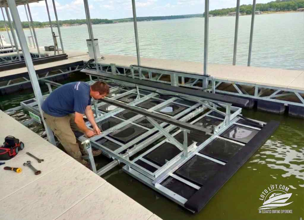 A service tech professional performing a boat lift installation in a covered dock slip at Lake of the Ozarks.