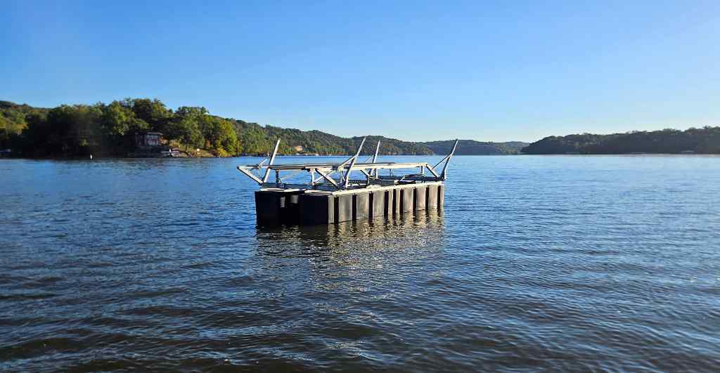 A boat lift floating on the water prior to installation.