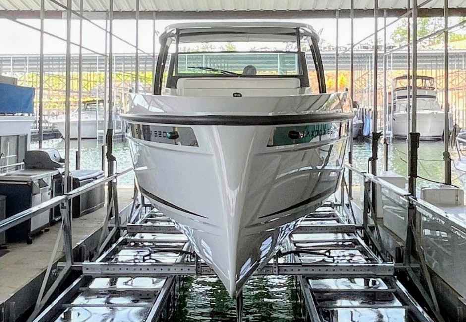 Professional pneumatic boat lift installation at Lake of the Ozarks holding a luxury boat safely in a covered slip - LOTO Lift Camdenton MO