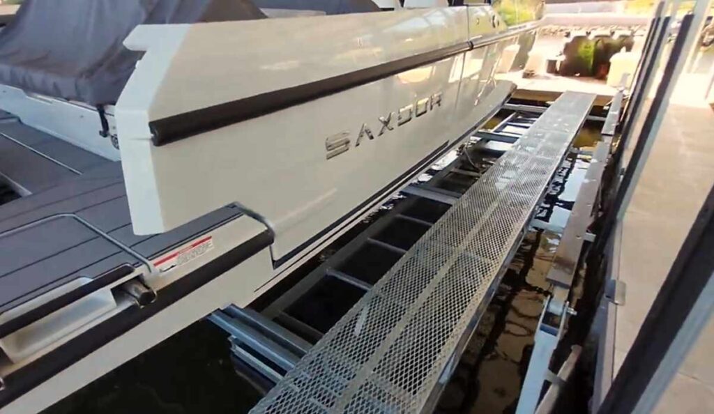 Side view of a luxury boat on a LOTO Lift system with integrated steel walkway at Lake of the Ozarks, showcasing easy access along the hull.