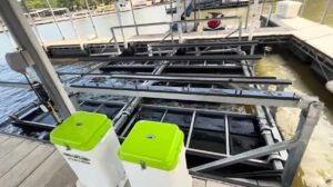 Wide slip boat lift at Lake of the Ozarks installed with dual remote units and stable multi-row frame on a wide dock.