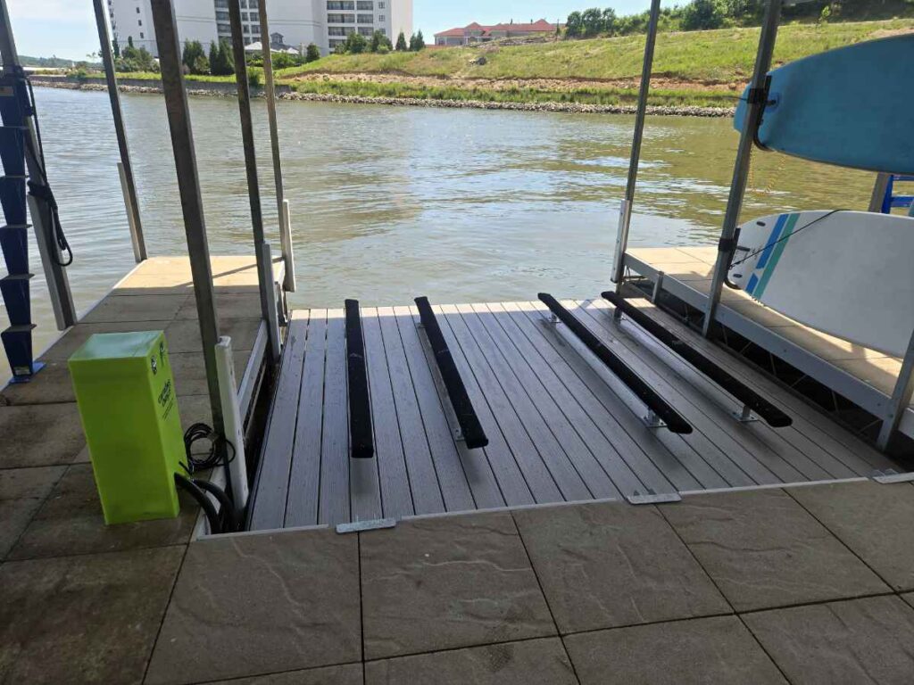 Dual pneumatic PWC platform lift with composite decking and Firstmate controls installed under a covered slip at Lake of the Ozarks near Camdenton, Missouri.