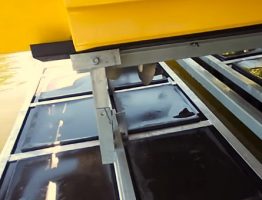 Close-up of a V-drive boat secured on a LOTO Lift shallow water drop-tank system showing the support arm and poly tanks.